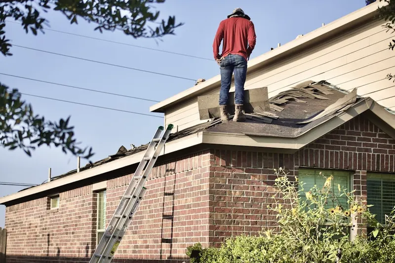 Professional roofer working on a residential roof in Woodwind